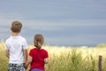 Little boy and little girl standing holding hands looking on horizont Royalty Free Stock Photo