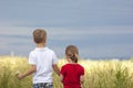 Little boy and little girl standing holding hands looking on horizont Royalty Free Stock Photo