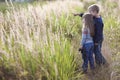 Little boy and little girl standing holding hands looking on horizont. Rear view. Royalty Free Stock Photo