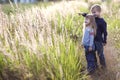 Little boy and little girl standing holding hands looking on horizont. Rear view. Royalty Free Stock Photo