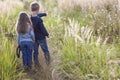 Little boy and little girl standing holding hands looking on horizont. Rear view. Royalty Free Stock Photo