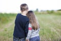 Little boy and little girl standing holding hands looking on horizont. Rear view. Royalty Free Stock Photo