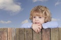 Little boy looking from above a fence, Royalty Free Stock Photo