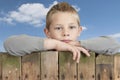 Little boy looking from bove a fence Royalty Free Stock Photo