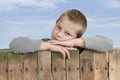 Little boy looking from bove a fence Royalty Free Stock Photo