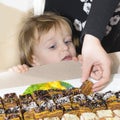 Little Boy Looking Curious at Cakes