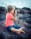 Little boy looking far away with binoculars Royalty Free Stock Photo