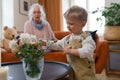 Little boy looking at flowers in vase. Royalty Free Stock Photo