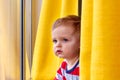 Little boy looking out the window. Close-up. Royalty Free Stock Photo