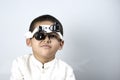 Boy looking through magnifying eyeglasses Royalty Free Stock Photo