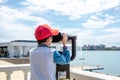 Little boy looking into tourist telescope eyepiece. Travel tourist destination landscape magnification