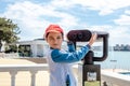 Little boy looking into tourist telescope eyepiece. Travel tourist destination landscape magnification