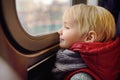 Little boy looks out the window of the car in the subway in New York, USA Royalty Free Stock Photo