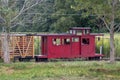 Little boy looks out the window of a red caboose train car Royalty Free Stock Photo