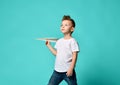 Little boy looks up in sky watches something in sky and holds a paper plane. new begining. Royalty Free Stock Photo