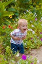 Little boy in a lush garden Royalty Free Stock Photo