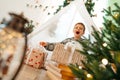 A little boy lying in a children& x27;s wigwam decorated for Christmas