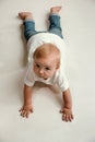 Little boy lying down on floor and looking up to the side Royalty Free Stock Photo