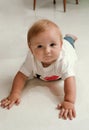 Little boy lying down on floor and looking up to the side Royalty Free Stock Photo