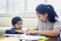 Little boy makes a paper plane with his mother Royalty Free Stock Photo