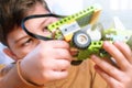 Little boy makes robot toy car. Smart boy assemble constructor kids workshop. Smart child science class robotics kids