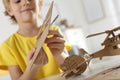 Little boy making carton toys at table, closeup. Creative hobby Royalty Free Stock Photo