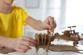 Little boy making carton toys at table, closeup. Creative hobby Royalty Free Stock Photo