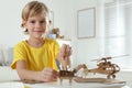 Little boy making carton toys at table. Creative hobby Royalty Free Stock Photo