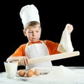 Little boy making pizza or pasta dough. Royalty Free Stock Photo