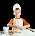 Little boy making pizza or pasta dough. Royalty Free Stock Photo