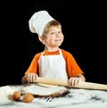 Little boy making pizza or pasta dough. Royalty Free Stock Photo