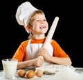 Little boy making pizza or pasta dough. Royalty Free Stock Photo