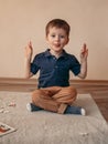 Little boy is meditating in the lotus position and smyling. yoga for young children Royalty Free Stock Photo