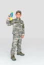 little boy in military uniform holding toy water gun Royalty Free Stock Photo