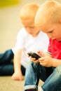 Little boy with mobile phone outdoor. Technology generation. Royalty Free Stock Photo