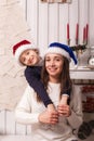 Little boy with mom posing in Christmas interior Royalty Free Stock Photo