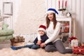 Little boy with mom posing in Christmas interior Royalty Free Stock Photo