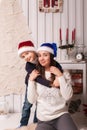 Little boy with mom posing in Christmas interior Royalty Free Stock Photo