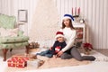 Little boy with mom posing in Christmas interior Royalty Free Stock Photo