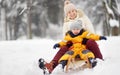 Little boy and mother/grandmother/nanny sliding in the Park during a snowfall Royalty Free Stock Photo