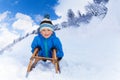 Little boy in mountains slide on sledge Royalty Free Stock Photo