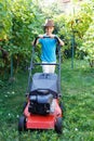 Little boy mowing lawn in backyard Royalty Free Stock Photo