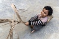 A little boy in a multicolor-shirt plays of his house on a summer day. A Kid Children Playing in the outdoors Royalty Free Stock Photo