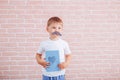 Little boy with a mustache holding a gift in his hands, father`s day, mother`s day Royalty Free Stock Photo