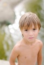 Little boy near water at the beach on hot summer day Royalty Free Stock Photo