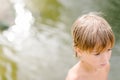 Little boy near water at the beach on hot summer day Royalty Free Stock Photo