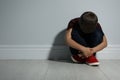Little boy near white wall. Domestic violence concept Royalty Free Stock Photo
