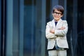 Little boy in a nice suit and glasses. Back to Royalty Free Stock Photo