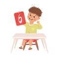 Little Boy with Number Six Sitting at Desk Showing Card with Numeral Vector Illustration