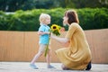 Little boy offering bunch of sunflowers to his mom Royalty Free Stock Photo